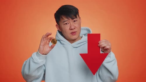 Asian Man Show Bitcoins BTC Down Sign Decrease of Exchange Rate Fall of Stock Cryptocurrency Market