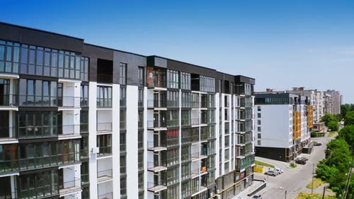 New highrise building in the city street. Modern design of newly built apartment building