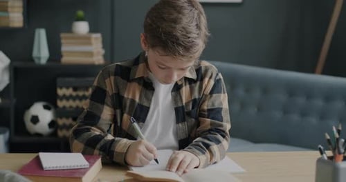 Boy Doing Homework in His Room