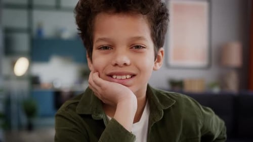 Young Boy Smiles in Home Interior