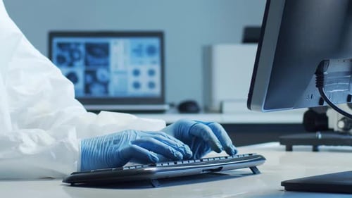 Scientist in Protection Suit and Masks Working in Research Lab Using Laboratory Equipment