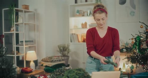 Woman Preparing Christmas Wreath Garland For Christmas Holidays
