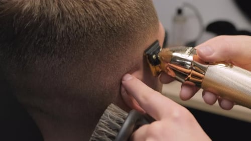 Barber Using Electric Razor to Trim Hair