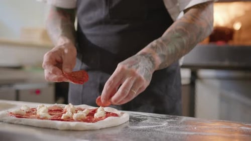 Chef Prepares a Delicious Pepperoni Pizza