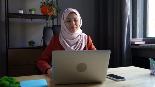 Smiling Woman Video Conferencing in Home Office