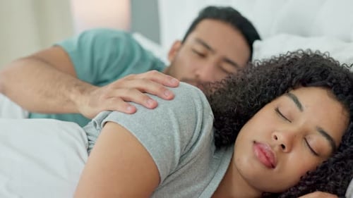 Young Couple Sleeping Peacefully in Bed Together