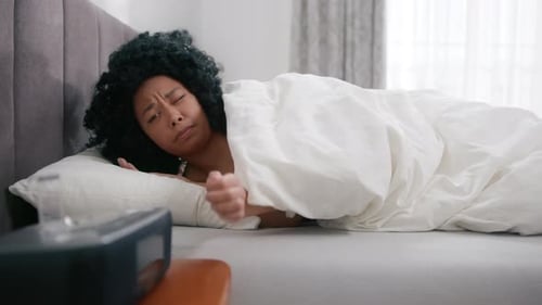 Woman Turns off Alarm in Bedroom