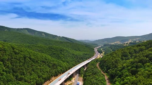 Construction of a new freeway in the spectacular wooded mountains.