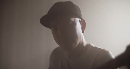 Artist Playing Bass Guitar in Music Studio