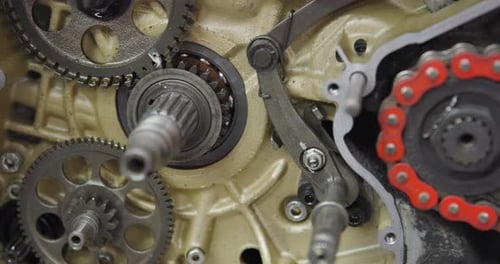Close Up Of Gears Of A Motorcycle Transmission Engine Under Repair. slider shot