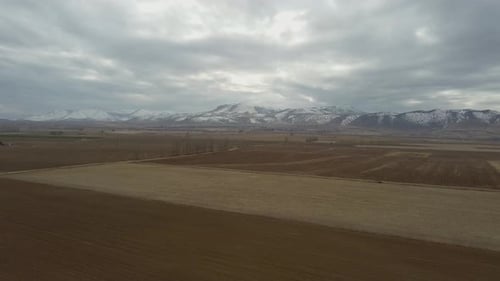 Aerial Fields and Snowy Mountains 4K
