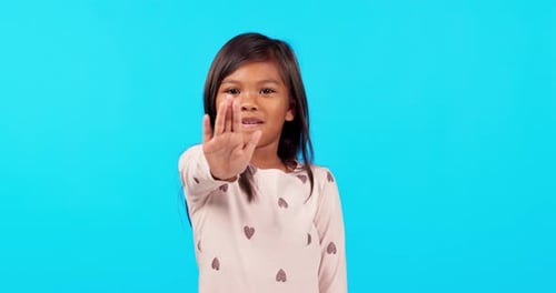 Hand, stop and girl child face in studio with warning, reject or no sign