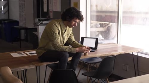 Businessman Taking A Break With Smart Phone In Office Slow Motion