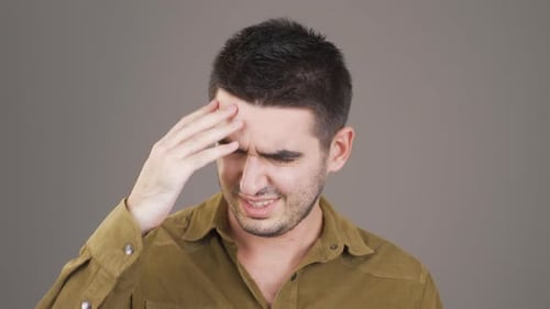 Confused Man Scratching His Head in Studio