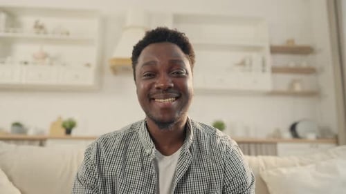 Friendly Man Waving and Smiling Indoors