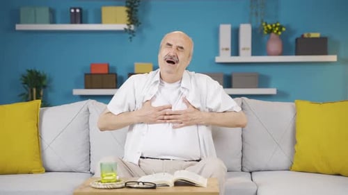 Man Experiencing Discomfort Sitting on Couch