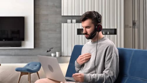 Young Adult Working Remotely on Laptop at Home