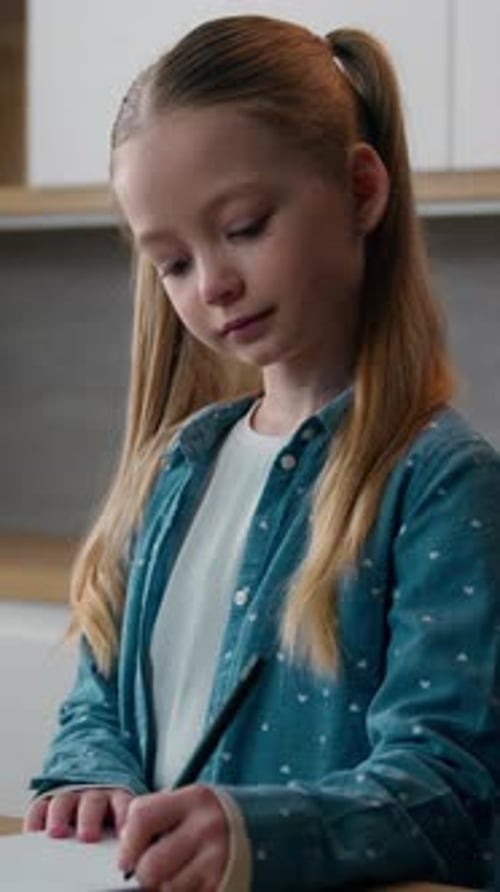 Caucasian Kid Girl School Pupil Elearning in Apartment Homeschooling Studying Online in Kitchen