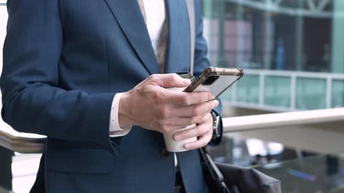 Close Up Businessman with Coffee and Smart Phone 4044 Years