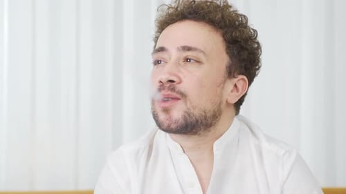 Man Exhaling Vapor from Device Close Up