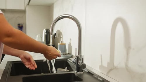 Intimate Shot of Female Hands Washing and Drying Dishes to Maintain Cleanliness