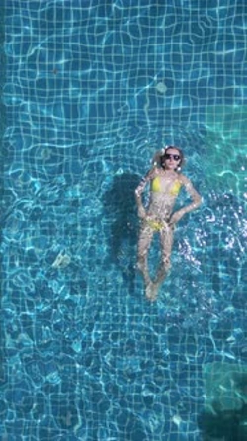 Caucasian Woman Swimming on the Back in the Pool in Slow Motion