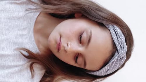 Girl with Brown Hair Stares at Camera