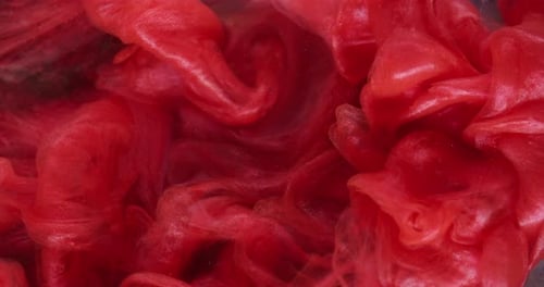 Abstract Red Liquid Swirling in Water