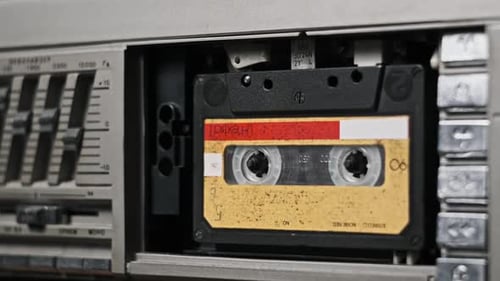 Audio Tape Recorder Playback Insert and Eject Yellow Audio Cassette CloseUp