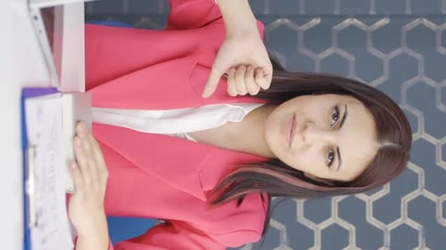 Businesswoman Gives Thumbs Down to Report in Office