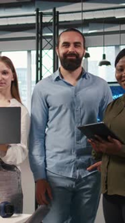 Vertical Video Portrait of Smiling Teamworking Programmers Utilizing AI to Optimize Performance