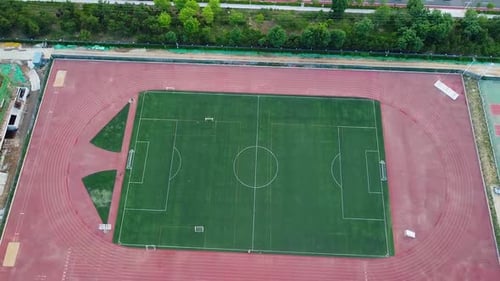 Cinematic aerial ascending tilt-up view of a soccer football field