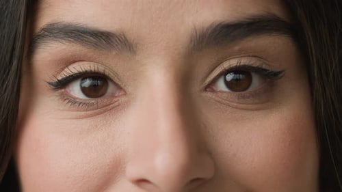Close Up Female Dark Black Eyes with Natural Makeup Eyeliner on Eyelid Long Eyelashes Looks at