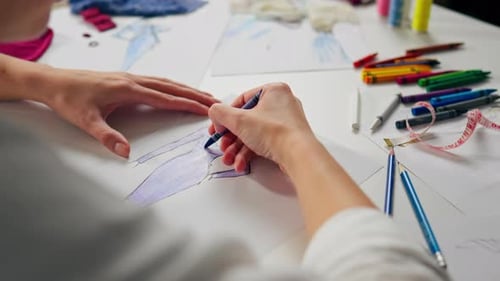 Fashion Designer Coloring Fashion Sketch on Paper