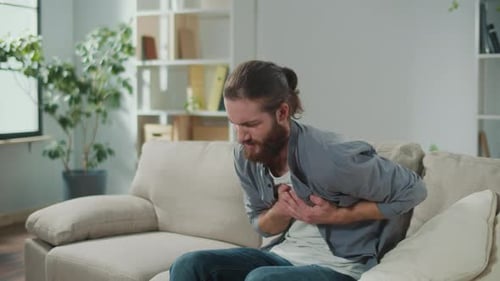 Man Clutching His Chest in Painful Coughing Fit