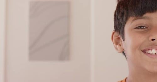 Smiling boy showing half face, close-up portrait in casual setting, copy space