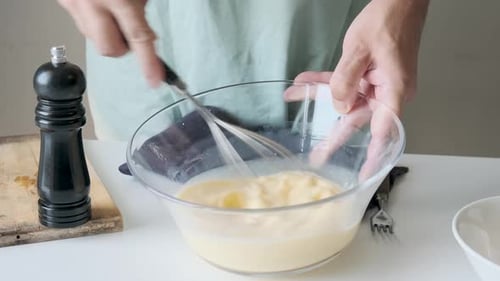 Mixing Eggs in Bowl with Whisk for Cooking
