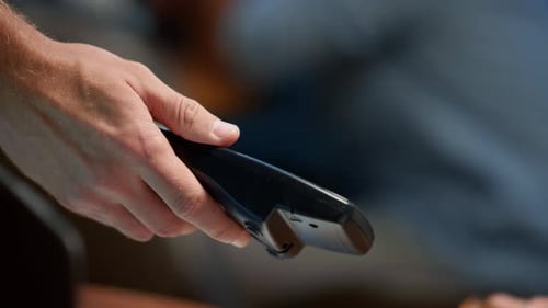 Businesswoman Hand Making Payment with Credit Card Through Pos Terminal. Closeup Lady