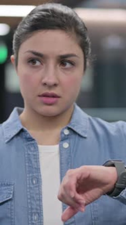 Young Woman Checking Her Smart Watch Indoors