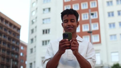 Young Adult Using Smartphone in City Environment