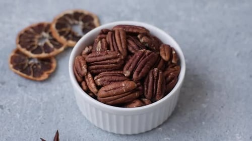 Peeled and roasted pecan nut as an ingredient for healthy food. Pecan nut as a food background