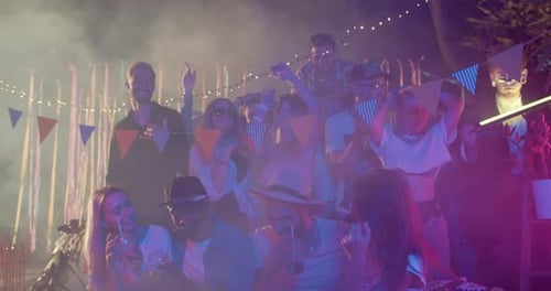 Diverse Group Celebrates with Drinks at an Outdoor Party
