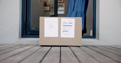 Woman Picks Up Package from Front Door Porch