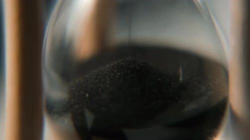 Black Sand Pours Into Lower Glass Chamber