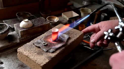 Gold Wedding Ring Making By Goldsmith Isolated Jeweler Melts Gold in Liquid State in Crucible