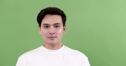 Joyful smiling man studio portrait bright green background close-up emotions