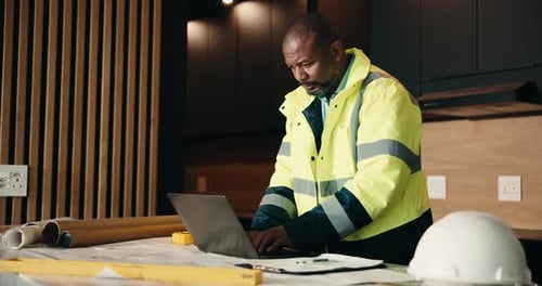 Laptop, renovation and thinking with black man in kitchen for home improvement or upgrade project