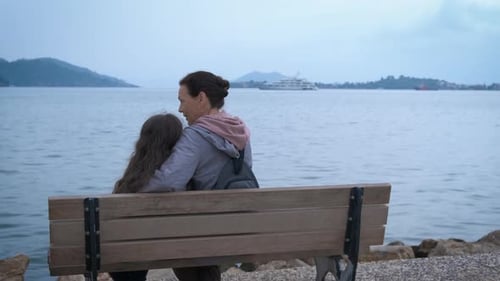 Woman and Child on a Bench by the Sea