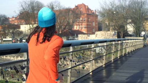 Young Woman Jogging on Bridge in City, Super 240