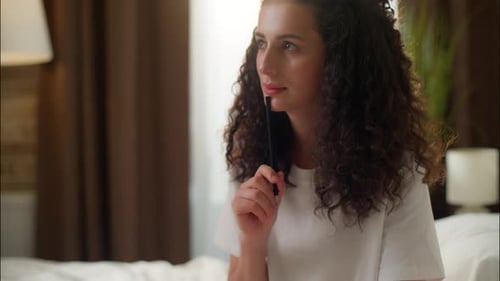 Woman Writing in Journal in Sunny Bedroom